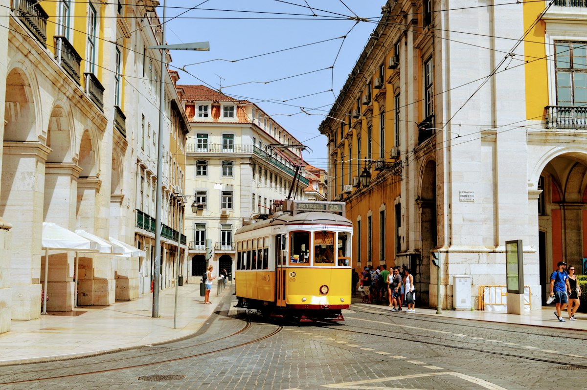 A classic yellow tram on a street in Lisbon, Portugal