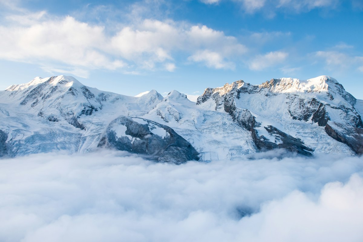 Snow-capped Swiss Alps above the clouds